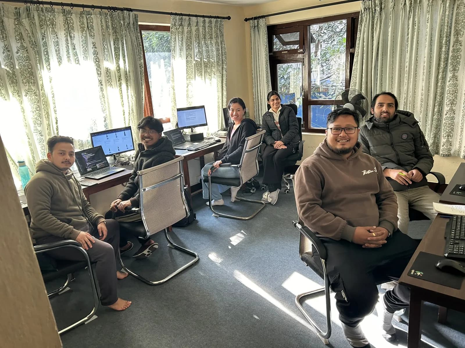 A full room of colleagues at their workstations