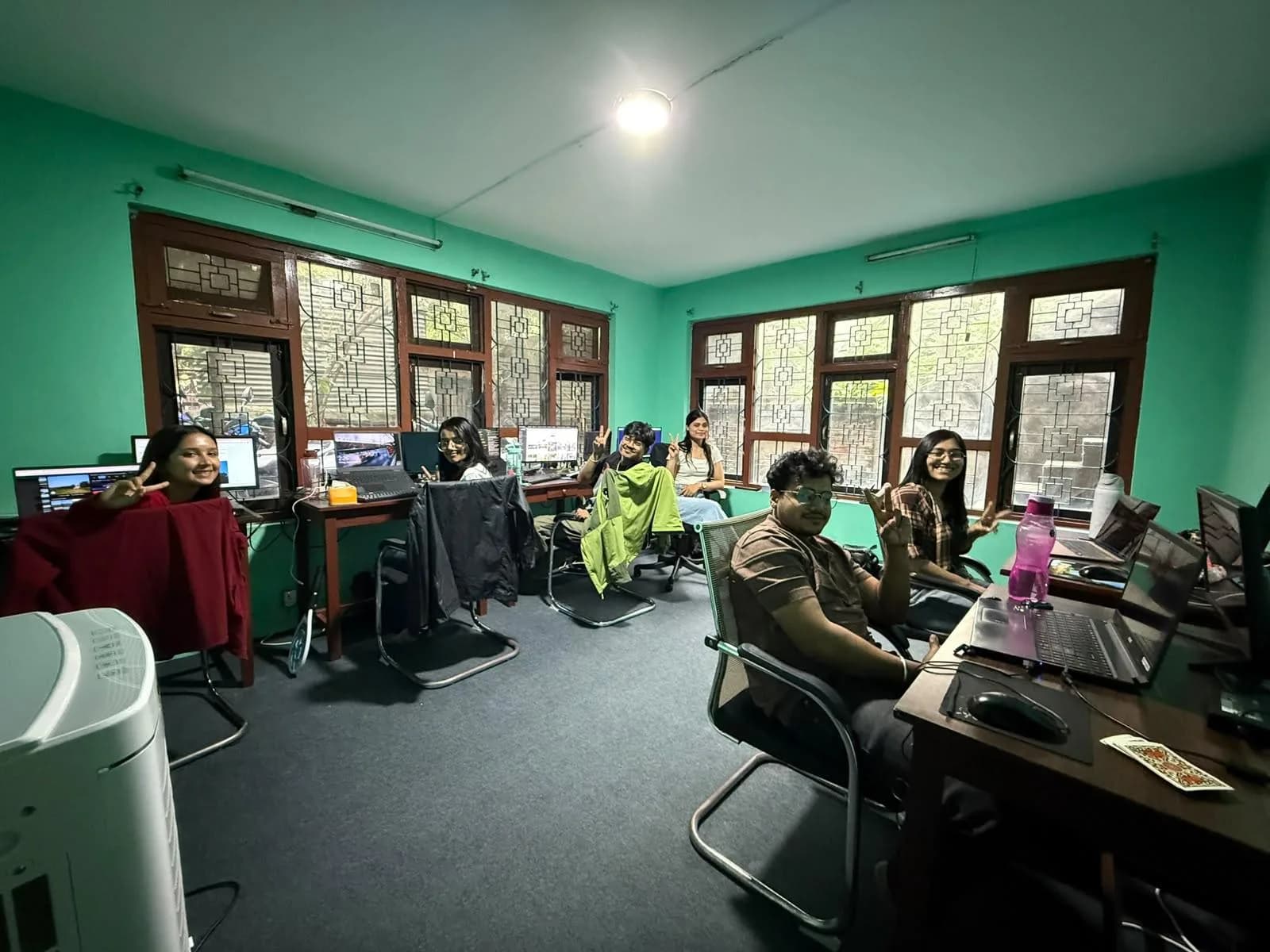 Team members at their desks in the main room of the Kathmandu office
